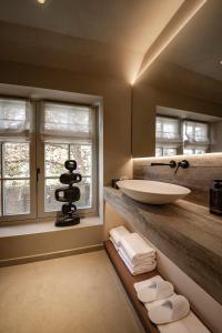 a bathroom with a sink and two windows at Le Diez Boutique Hotel in Den Bosch +77 photos