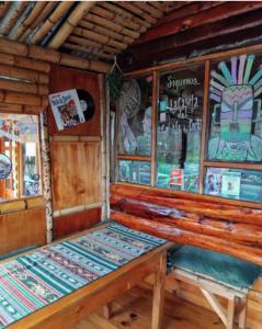 a bench in the back of a train room at The Temple, Laguna de la Cocha in El Encano