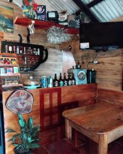 a room with a table and a counter with bottles at The Temple, Laguna de la Cocha in El Encano