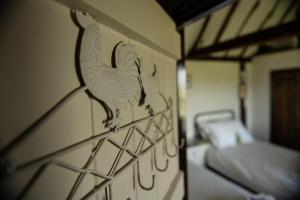 a room with a wall with a bird on it at Coldharbour Cottage with Hot Tub in Stone