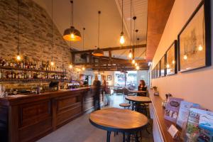 a restaurant with two tables and a bar at Olivers Central Otago in Clyde