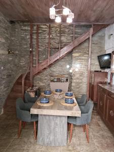 a dining room with a table and some chairs at ZERVOU House in Batsi