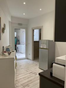 a kitchen with a refrigerator and a counter top at Naxos Maréa Apartament in Giardini Naxos +17 photos