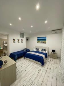 a bedroom with two beds and a bathroom at Naxos Maréa Apartament in Giardini Naxos