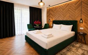a bedroom with a large bed in a room at Arena Park in Bucharest