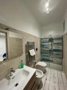 a bathroom with a white sink and a toilet at Naxos Maréa Apartament in Giardini Naxos