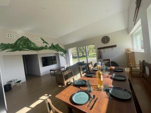 a dining room with a wooden table and a dining room at L'Atelier de Gabs in Aramits