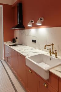 a kitchen with a sink and a stove at Karma Rooms in Ternopil +7 photos