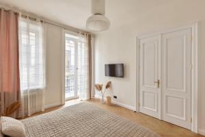 a white room with a bed and a window at Karma Rooms in Ternopil