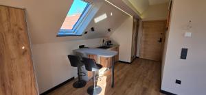 a small kitchen with a counter and stools in a room at KaMi Self check-in 24 h in Głogówek
