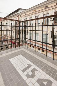 a balcony with a black railing and a building at Karma Rooms in Ternopil