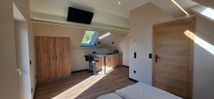 a bedroom with a bed and a desk and a door at KaMi Self check-in 24 h in Głogówek