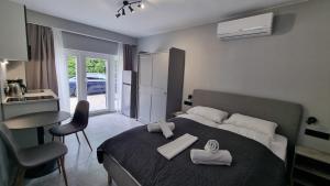 a bedroom with a bed with two folded towels on it at Lucky Villa in Hévíz