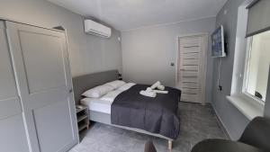 a bedroom with a bed with a stuffed animal on it at Lucky Villa in Hévíz