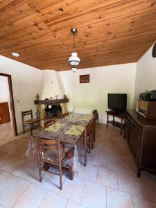 a dining room with a table and a television at appartement olivese in Olivese +1 photo