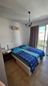 a bedroom with a bed and a chandelier at Villa Caesar in Ayia Napa
