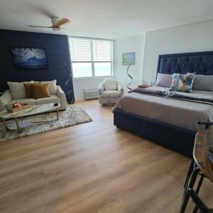 a large bedroom with a large bed and a couch at Cuddle's Comfort & OCEAN in Daytona Beach +36 photos