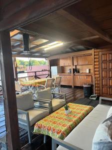 a living room with chairs and a table and a kitchen at Dori Cottage in Ada
