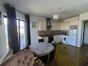 a kitchen with a table and a dining room at Bishops View in Galway