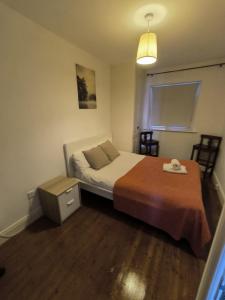 a small bedroom with a bed and a night stand at Bishops View in Galway