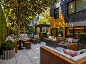 a patio with couches and tables and a building at Hala DC in Washington, D.C.