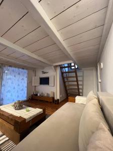 a living room with a couch and a table at Dori Cottage in Ada
