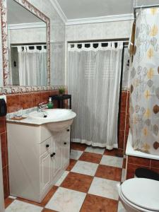 a bathroom with a sink and a toilet and a mirror at El Refugio in Aracena +28 photos