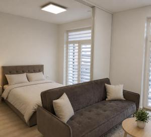 a living room with a couch and a bed at Apartment Ainiai in Panevėžys