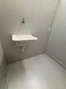 a bathroom with a white sink in a room at Casa da Dinda 202 in Rio das Ostras +8 photos