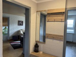 a mirror on a wall in a room at Ferienhaus in Altenfeld Thüringen mit Garten in Altenfeld