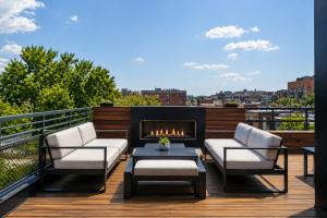 a patio with two chairs and a fireplace on a balcony at Hala DC in Washington, D.C.