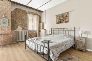 a bedroom with a bed and a brick wall at La Locanda Del Molino in Fortunago