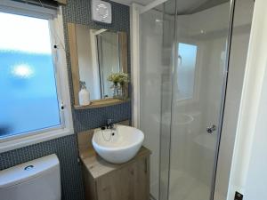 a bathroom with a sink and a shower at Modern Seton Sands Caravan - sleeps 6 in Port Seton
