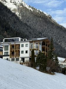 a building on top of a snow covered hill at Versalerhof in Ischgl