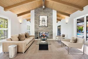 a living room with a couch and a fireplace at Desert Solstice in Palm Springs