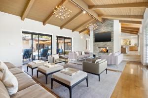 a living room with white furniture and a fireplace at Desert Solstice in Palm Springs