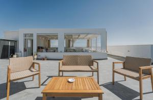 a group of chairs and a table with a coffee table at Ponente & Maestro Rooms in Favignana