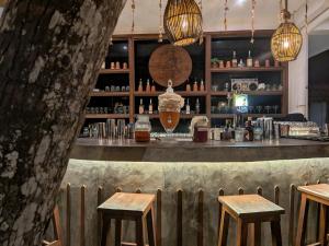 a bar with two stools in front of a counter at Dickwella Beach in Dickwella