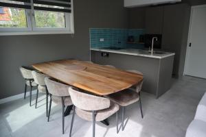 a kitchen with a wooden table and chairs at Burgvliet41 in Oostkapelle +17 photos