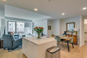 a living room with a kitchen and a dining room at Walk to MIT & T Stop! Kendall Square Extended Base in Cambridge