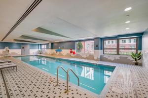 a large swimming pool in a hotel room at Walk to MIT & T Stop! Kendall Square Extended Base in Cambridge