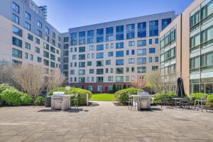 a courtyard with tables and chairs in front of a building at Walk to MIT & T Stop! Kendall Square Extended Base in Cambridge