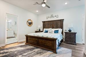 a bedroom with a bed and a ceiling fan at Let's get Beachy! in Bolivar Peninsula