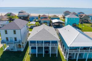 an aerial view of a town with houses and the ocean at Let's get Beachy! in Bolivar Peninsula