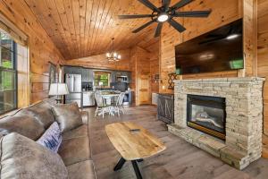 a living room with a couch and a fireplace at All About Romance by Venture Smoky Mountains in Henderson Springs