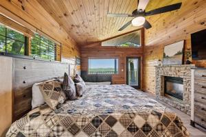 a bedroom with a large bed and a fireplace at All About Romance by Venture Smoky Mountains in Henderson Springs