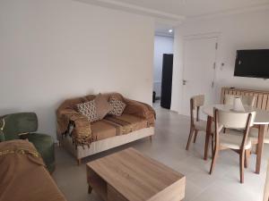 a living room with a couch and a table at La tulipe d'Hammamet in Hammamet