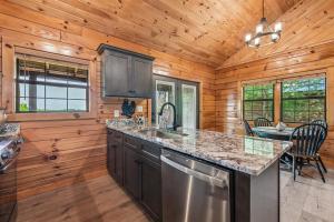 a kitchen with wooden walls and a wooden ceiling at A Hen House by Venture Smoky Mountains in Pigeon Forge