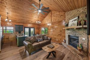 a living room with a couch and a fireplace at A Hen House by Venture Smoky Mountains in Pigeon Forge