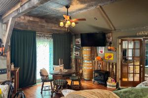 a living room with a table and chairs and a ceiling fan at Walk to Trails & Fishing Spots! Lake Ozark Escape in Four Seasons